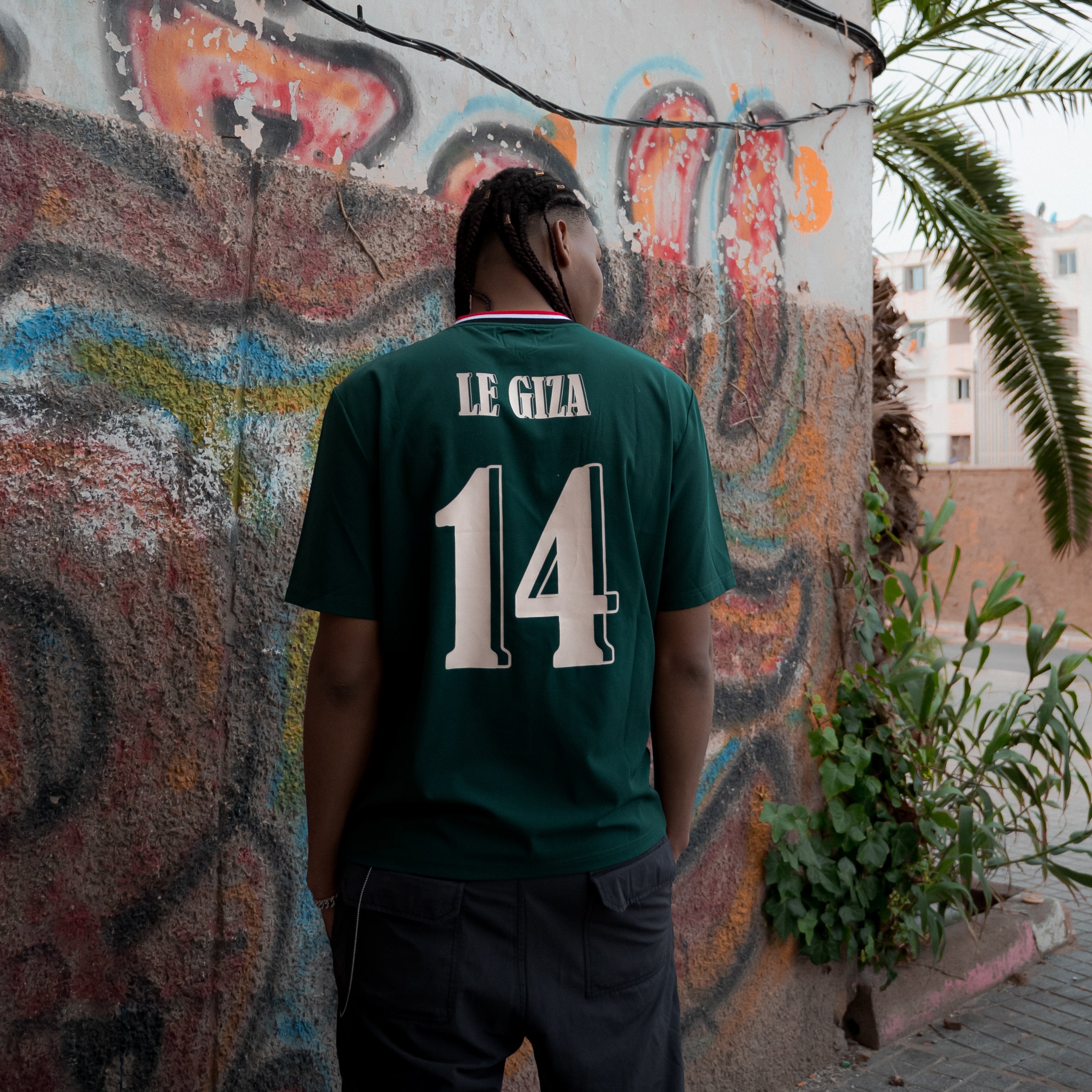 Abdul, 190cm tall, wearing a size Large of the Dark Green Le Giza Football Jersey.
