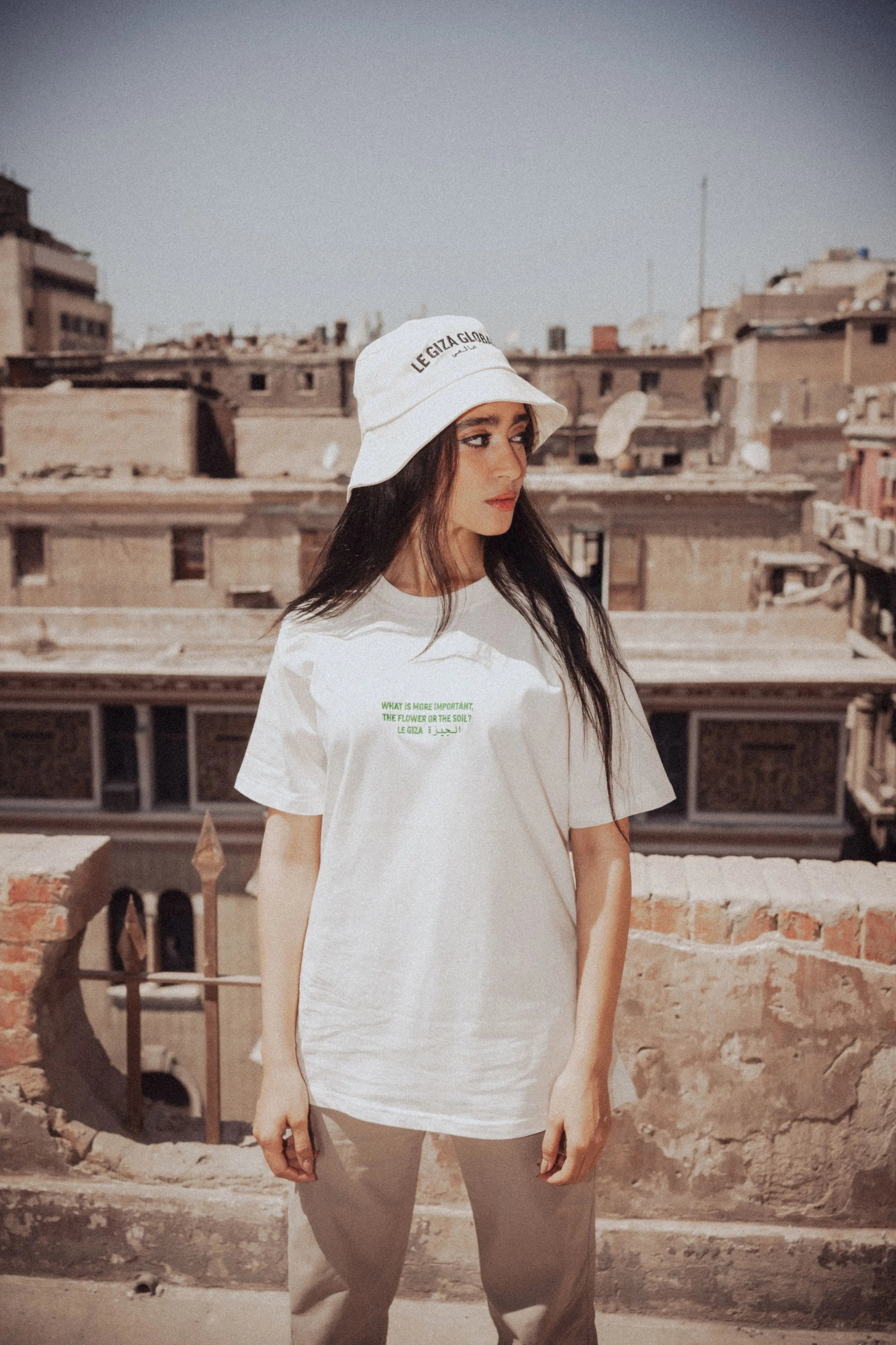 Model wearing the Crème Bucket Hat, showcasing its adjustable fit and unique embroidery.